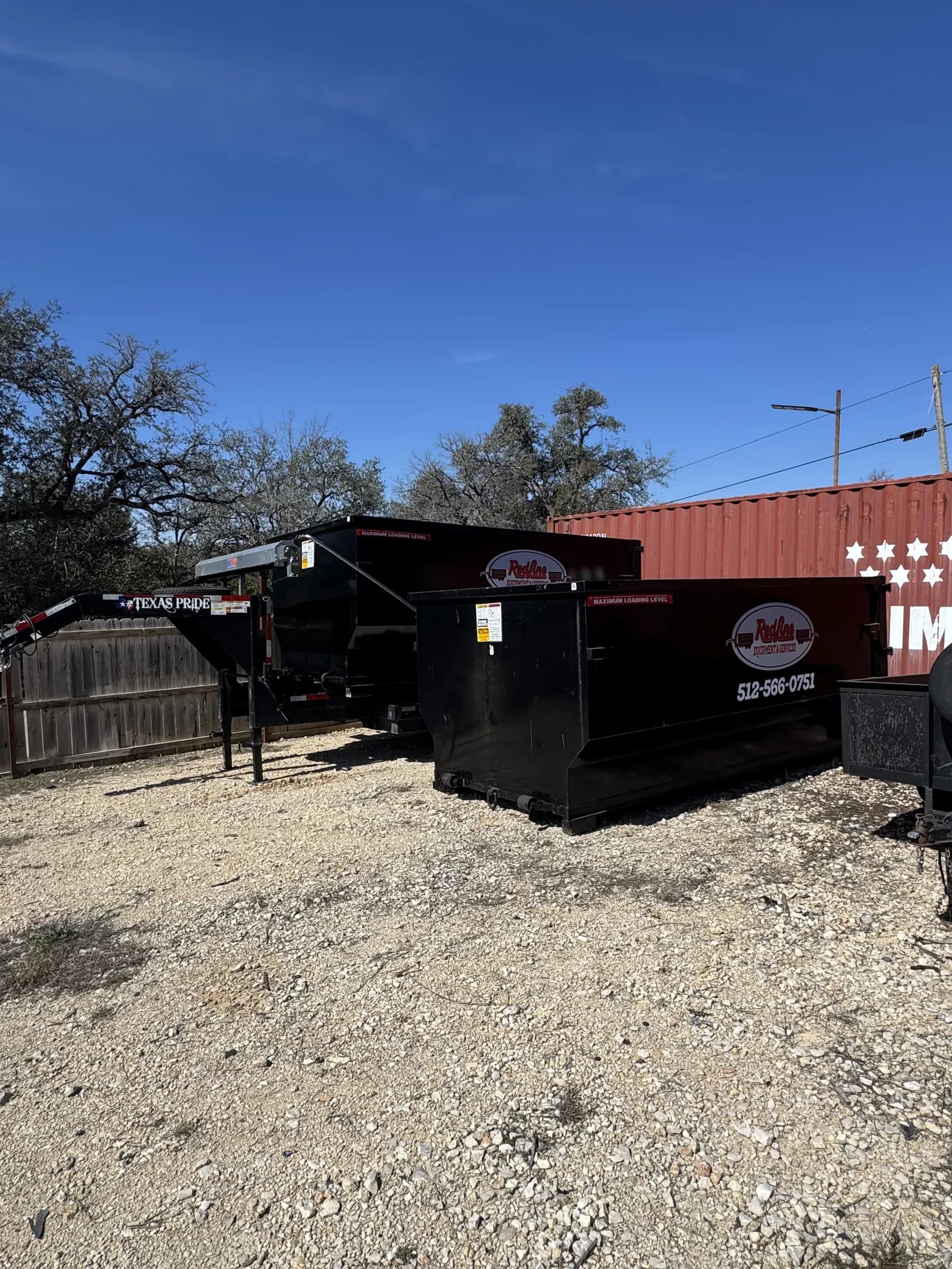 RedLine dumpster on a Hill Country gravel lot in Wimberley, Texas